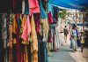 stores on sidewalk selling clothes