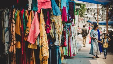 stores on sidewalk selling clothes