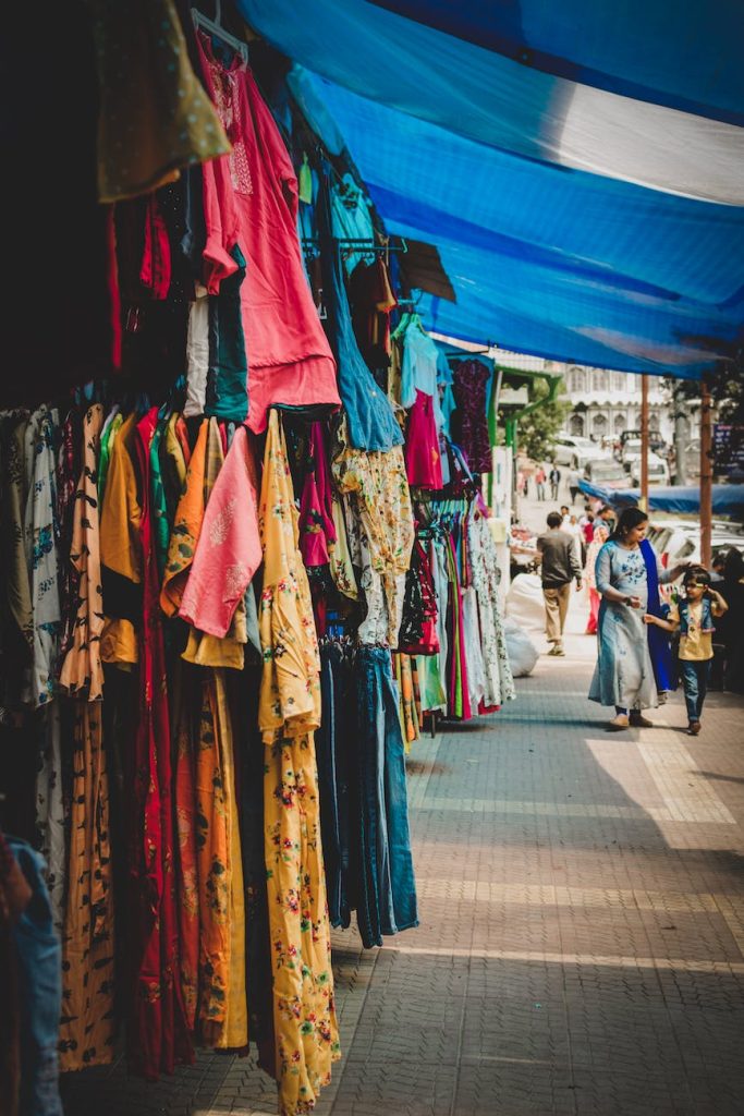stores on sidewalk selling clothes