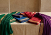 Preloved silk and georgette sarees arranged on a neutral background