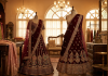 Pre-loved maroon and gold bridal lehenga in a boutique