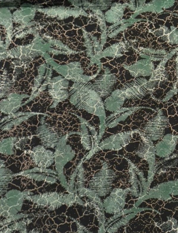 Fabric with green floral print on black background