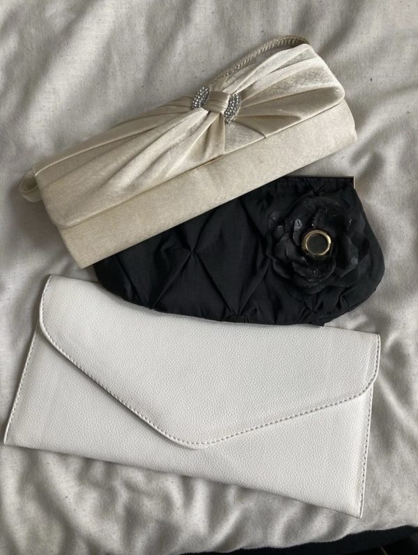 Three party clutch bags: beige, black, and white