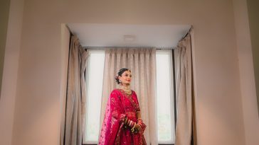 A South Asian bride in a preloved embroidered bridal lehenga