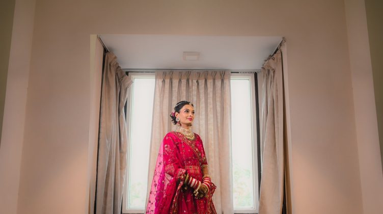 A South Asian bride in a preloved embroidered bridal lehenga