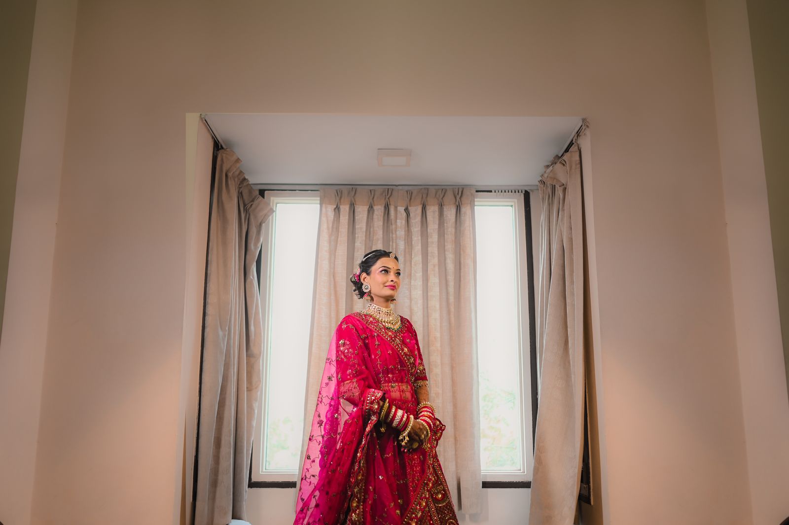 A South Asian bride in a preloved embroidered bridal lehenga