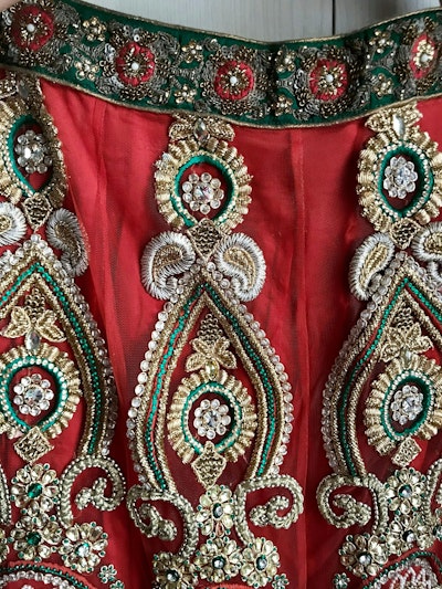 Rust Orange Bridal Lehenga with Gold, Red & Green Embroidery - Image 9